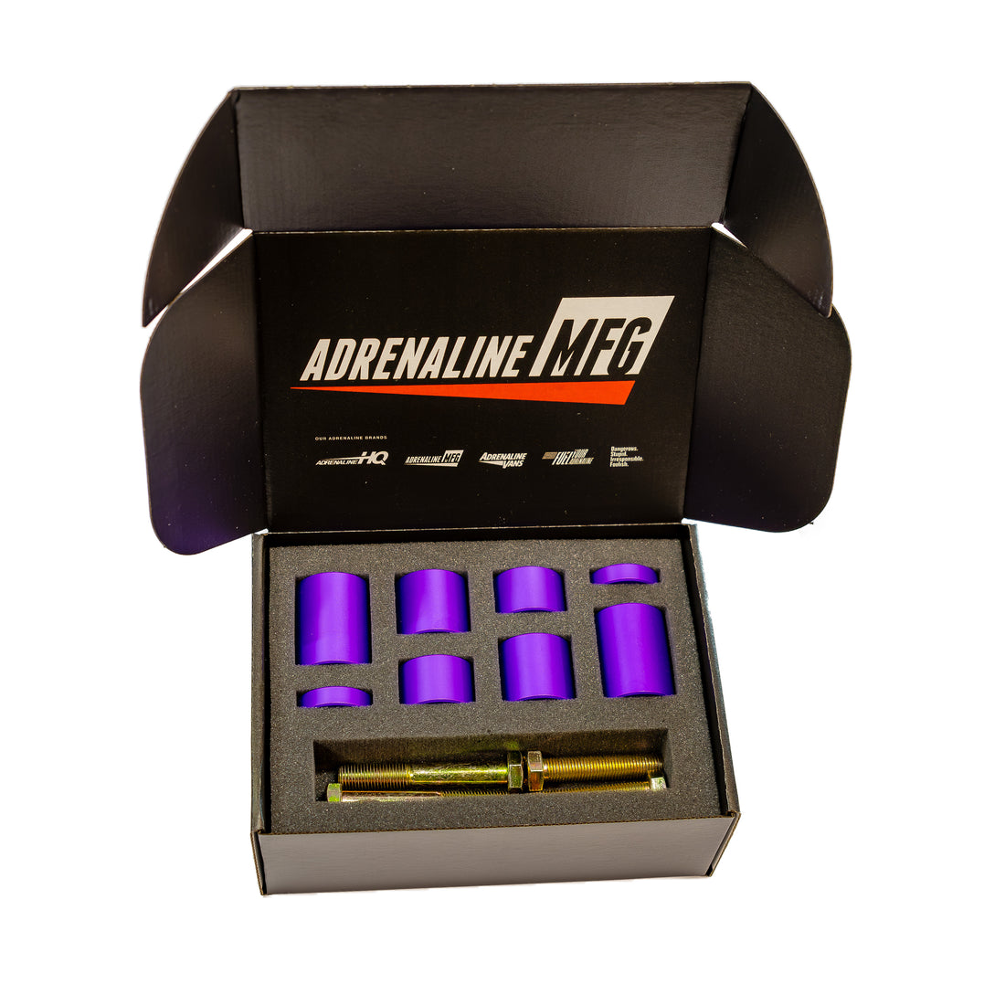 Purple suspension bushings and metal bolt set in foam packaging inside an open black box.