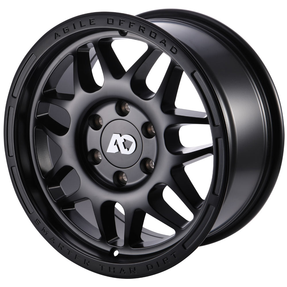 Matte black off-road wheel with ten spokes and engraved branding on the rim
