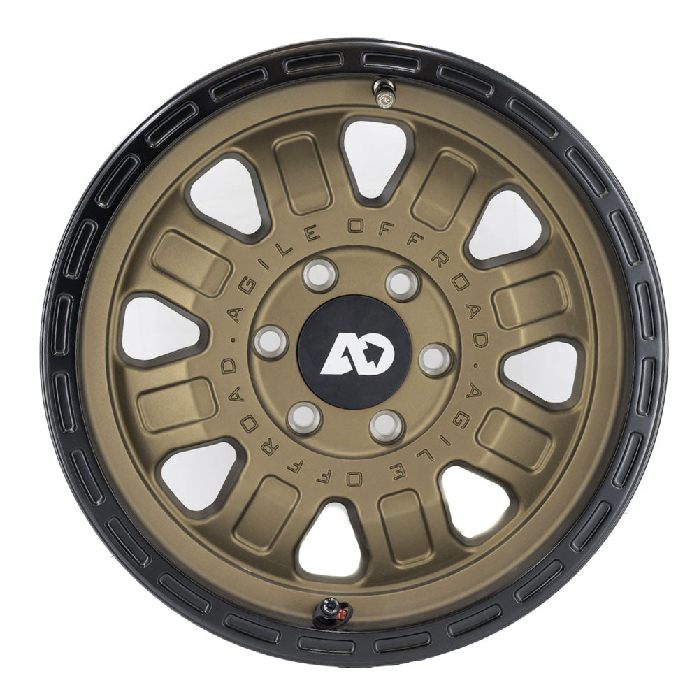 Matte bronze off-road wheel with black outer ring and multi-spoke design.