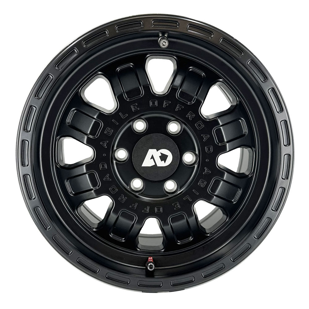 Black off-road wheel rim with multi-spoke design and bold center cap logo.