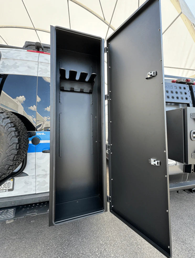 Tall, open metal storage box mounted on the rear of a camper vehicle.