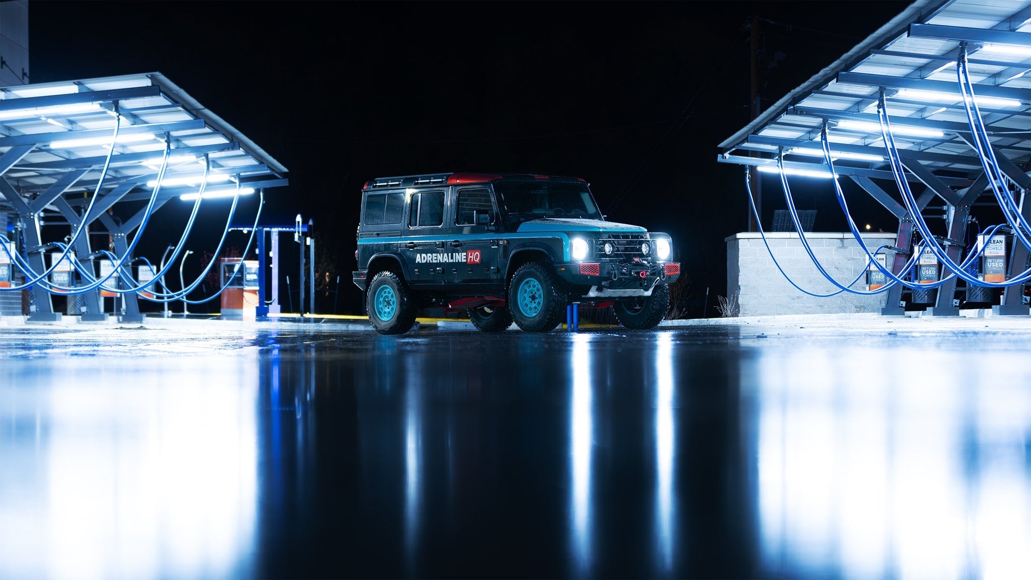 Upgraded Ineos Grenadier with LED lights illuminating a nighttime off-road scene