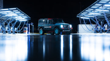 Upgraded Ineos Grenadier with LED lights illuminating a nighttime off-road scene