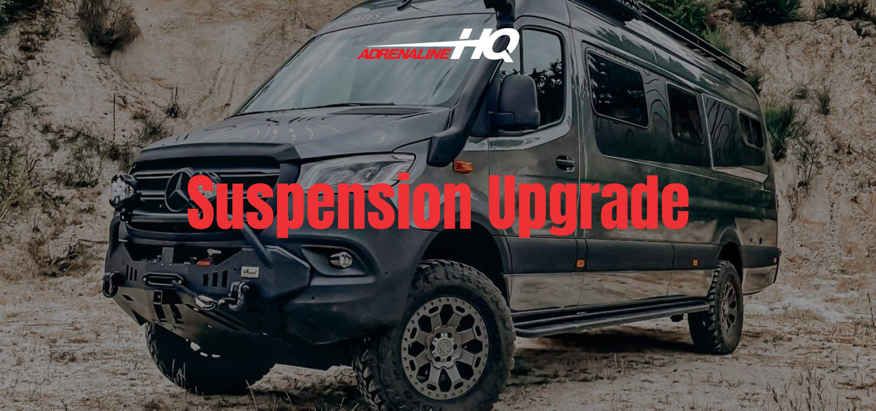 Off-road camper van parked on rocky terrain with cloudy sky above