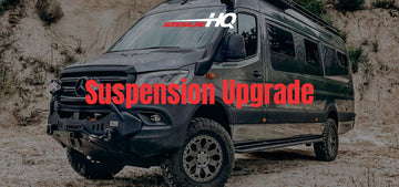 Off-road camper van parked on rocky terrain with cloudy sky above