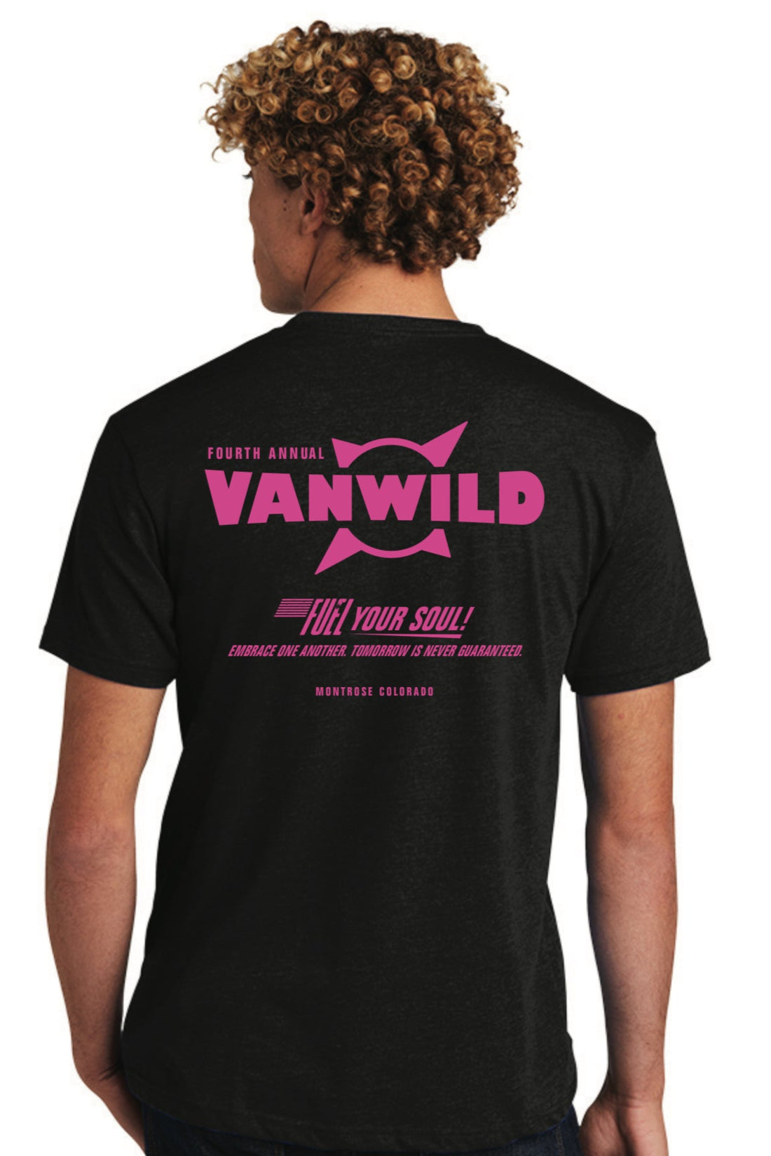 Person wearing a black t-shirt with pink 'Van Wild' logo and text on the back.