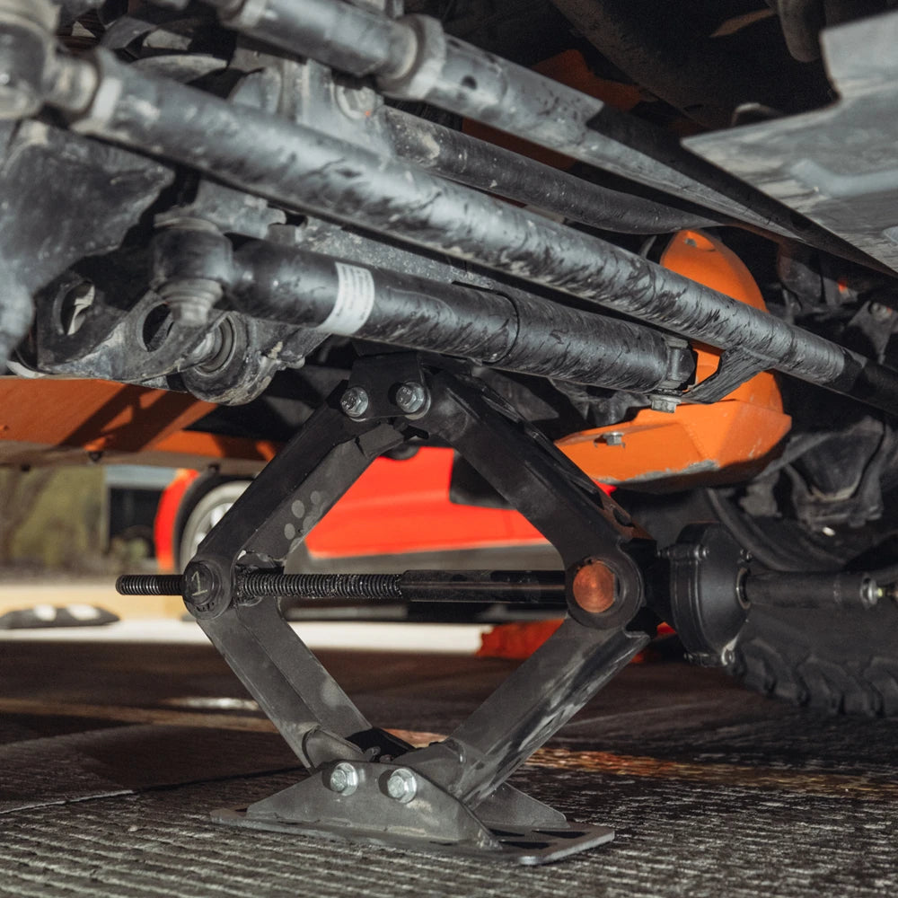 Agile Offroad heavy duty scissor jack lifting an off-road vehicle during trail repair, providing stable and reliable support.